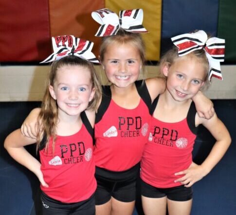 three young gymnasts posing for a picture after their gymnastics meet