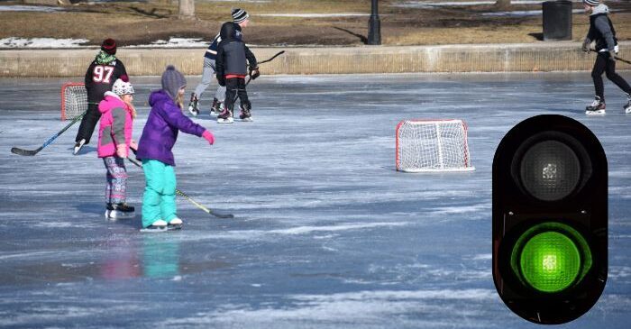 Children ice skating and playing hockey on the Lagoon.