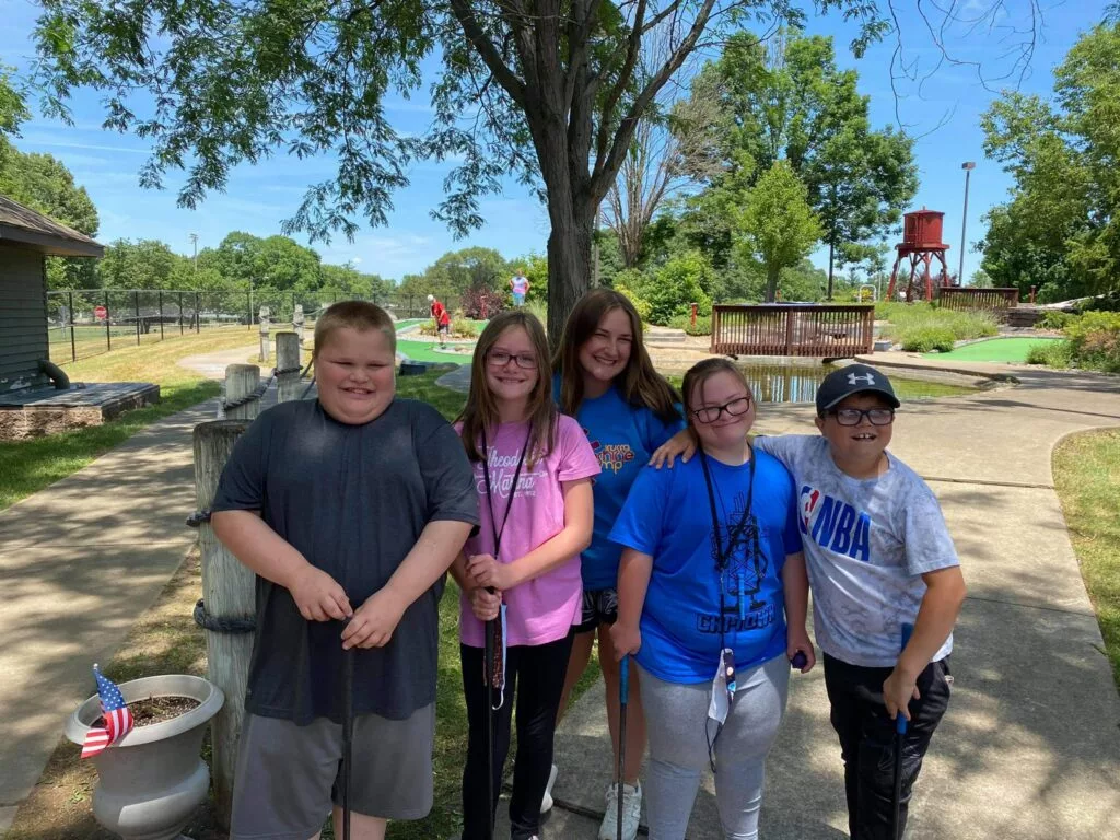 classmates playing mini golf at a mini golf course in Pekin